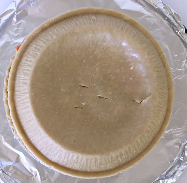 Place 2nd pie crust on top of chicken pot pie mixture, poke 2-3 holes and bake in oven for 40 minutes.