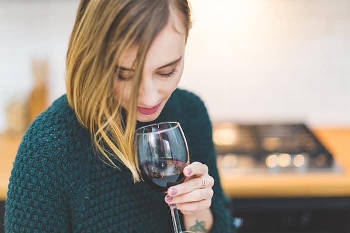 woman drinking glass of wine look younger